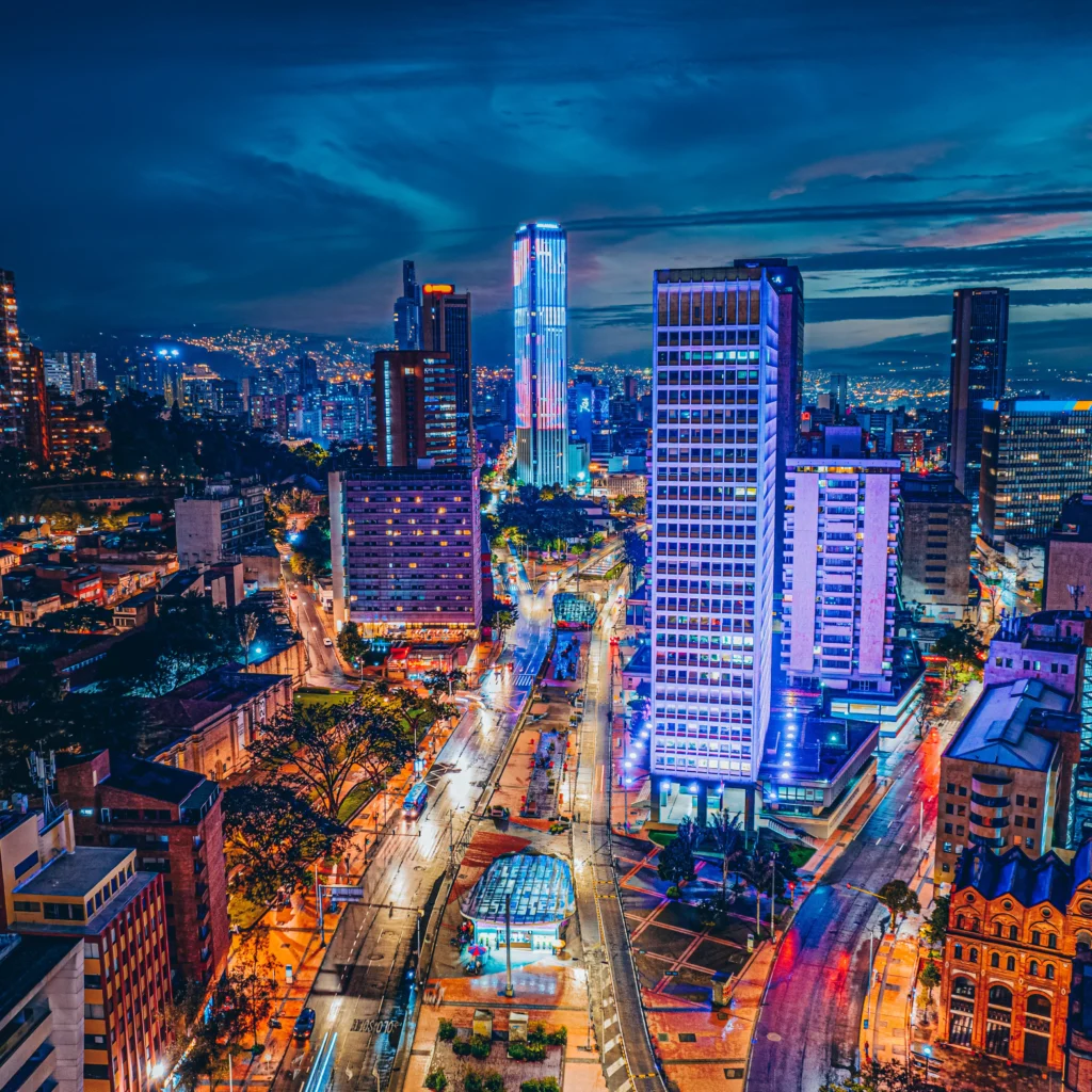 Bogotá high-rise buildings and illuminated streets at night.