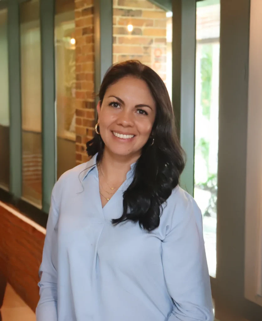 Portrait of Jinna Sánchez, CEO and Founder of TCA Staffing, in an office.