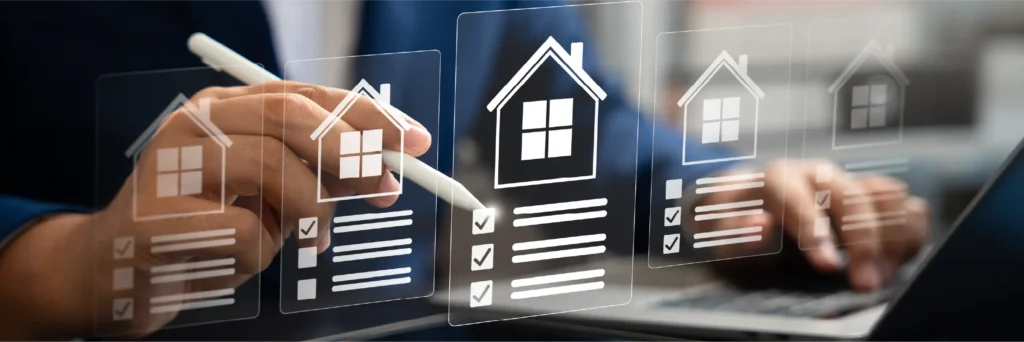 Hands using a laptop with house icons and property interface graphics.