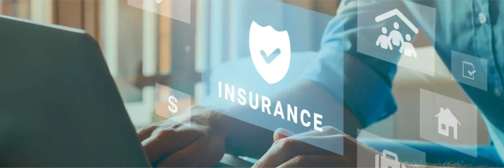 Person using a laptop with insurance symbols overlaid on the scene.